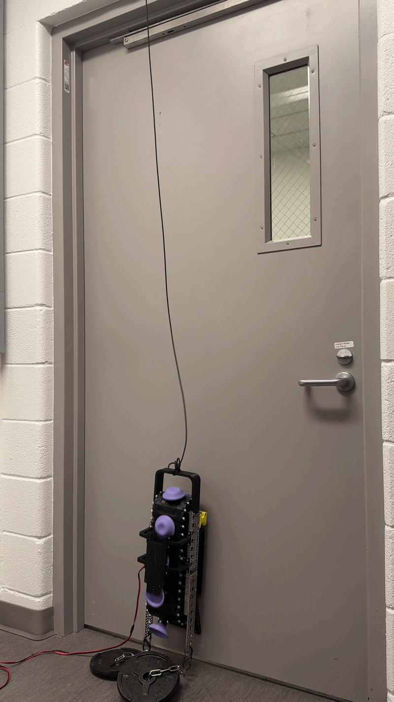 Wall-climbing robot carrying a payload up a vertical surface